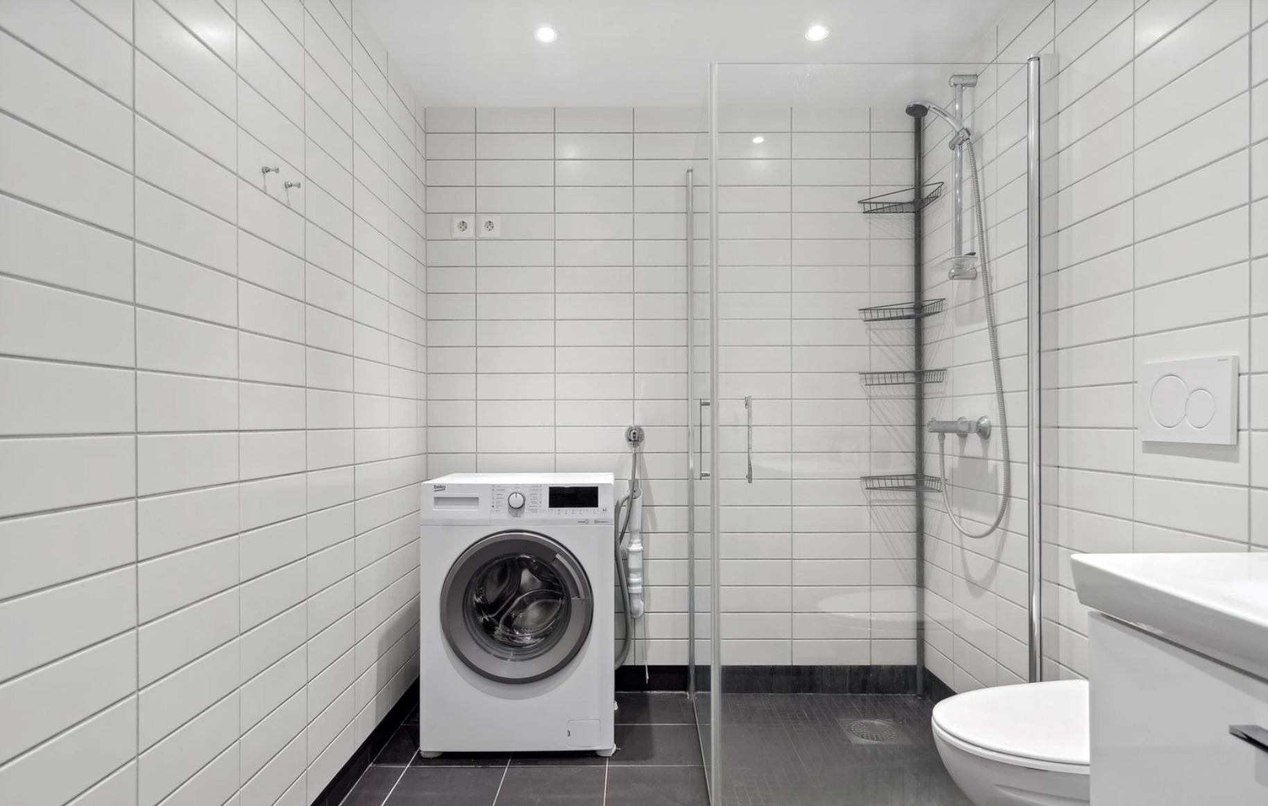 Bad er flislagt, og inkluderer vaskemaskin. 